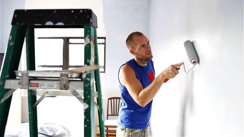 Person painting an interior wall