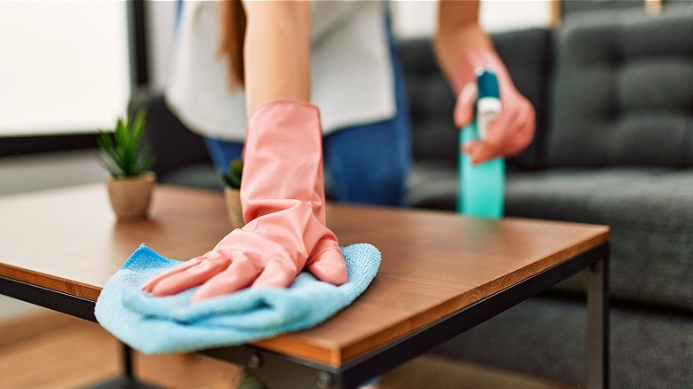 Person cleaning a table