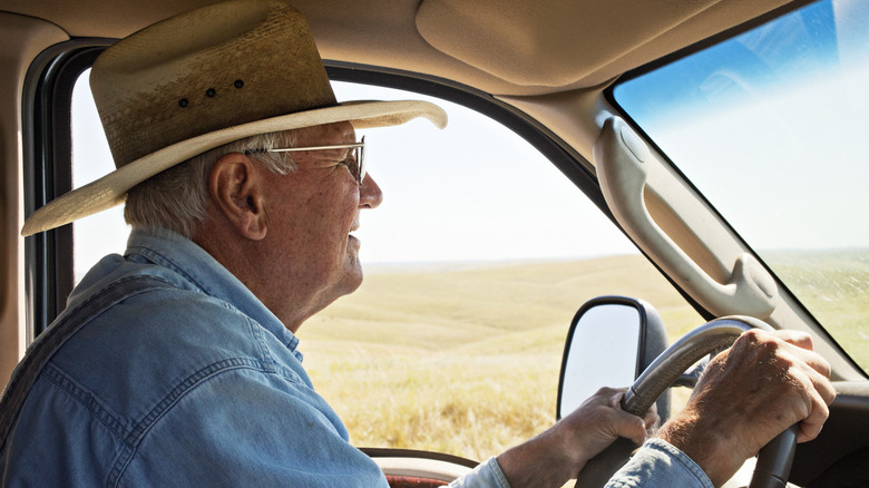 Senior man behind the wheel of a truck