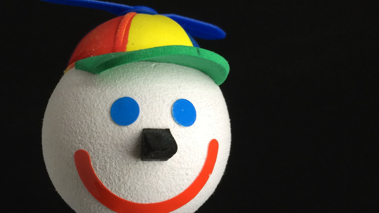 A Jack in the Box clown head antenna topper against a black background.