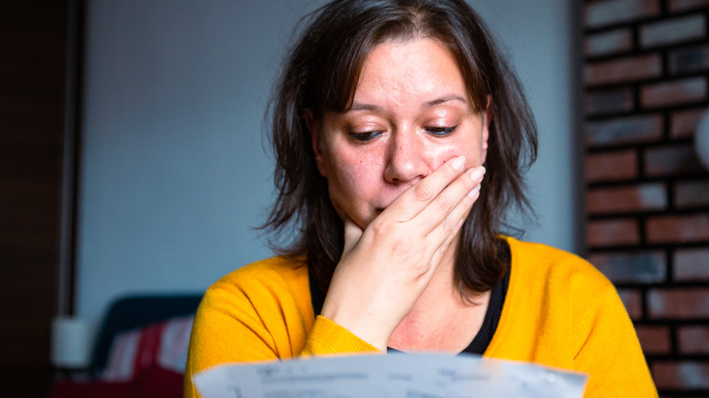 Woman looking at bills