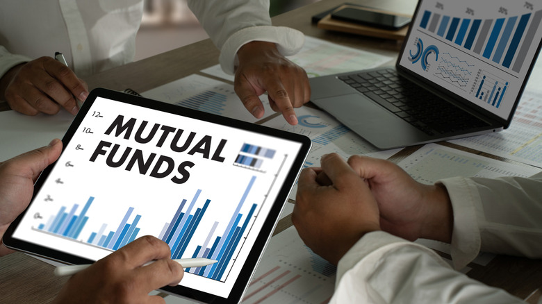 Group of people monitoring mutual funds on laptop