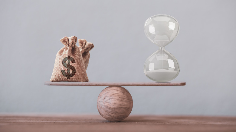 moneybag and hourglass on scale