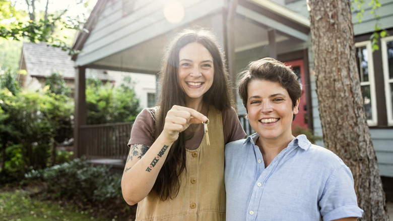 a couple holding keys to their house