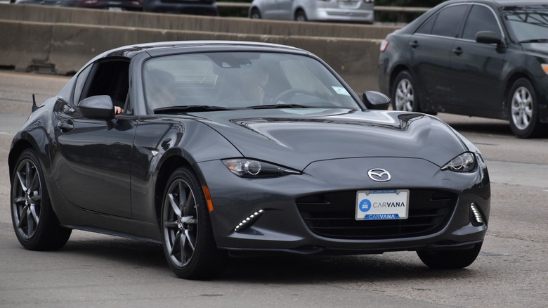 a black Miata on the road