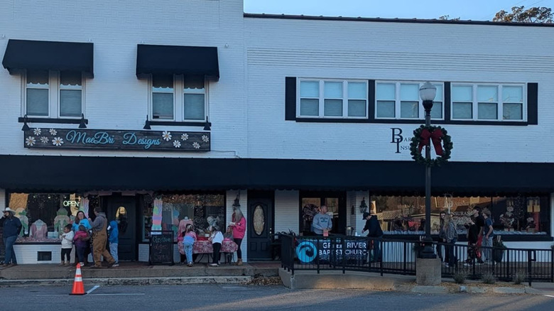 People standing outside a strip of stores in Downtown Waynseboro, Tennesee