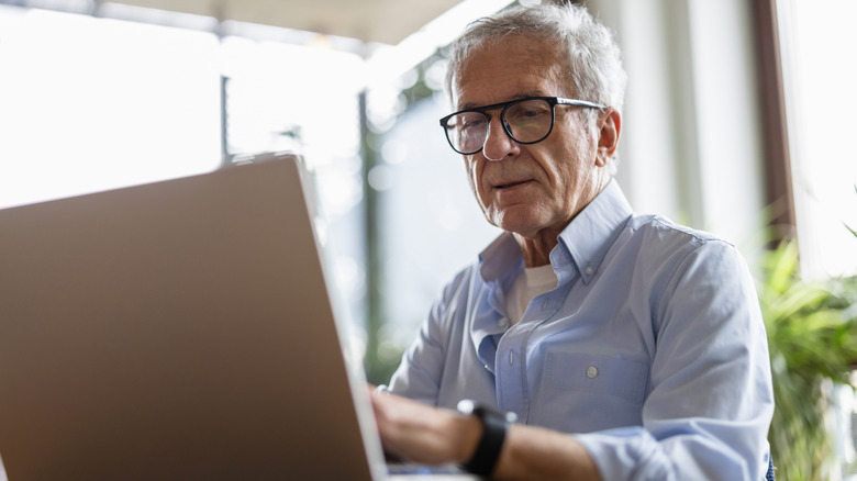 Senior man using laptop