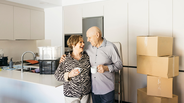 Senior couple celebrating moving into a new home