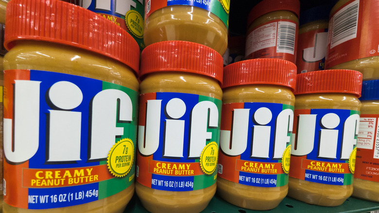 Row of creamy Jif peanut butter jars on a store shelf