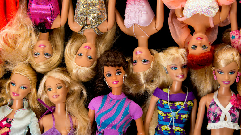 Top view of rows of Barbie dolls aranged in upside down and right side up pattern