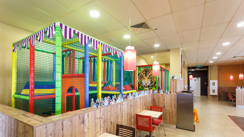 Interior in modern elite fast food cafe burger king with playground for children