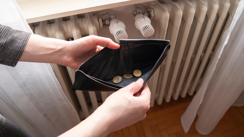 Person opening their empty wallet