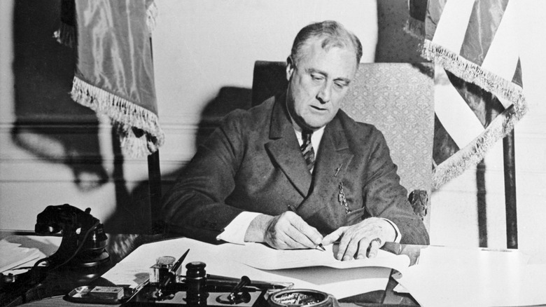President Roosevelt signing a bill at his desk