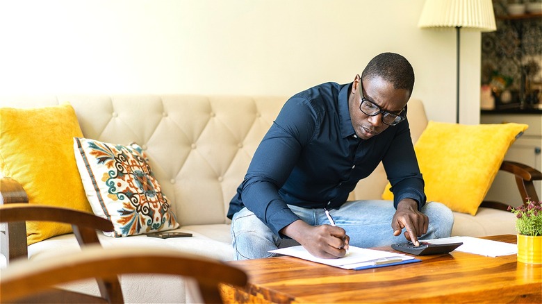 Person calculating finances at home
