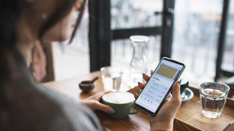 Woman looks at finances on phone