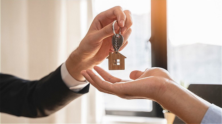 Agent handing keys to homebuyer