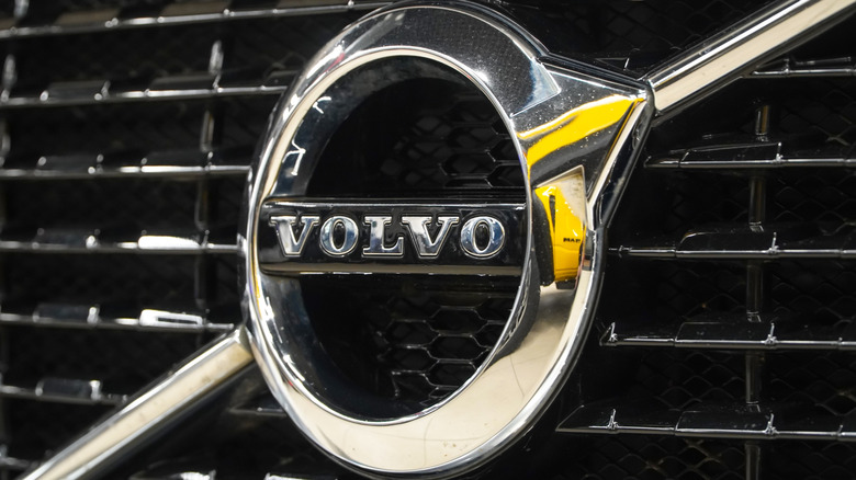 The front view of Volvo badge logo emblem with radiator grill selective focus.