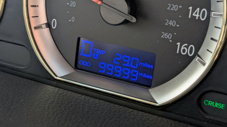 A car odometer at 99,999 miles.