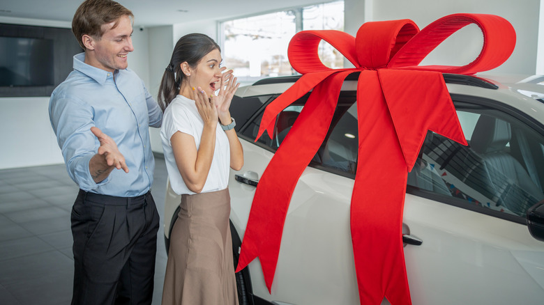 man giving woman a car as a gift