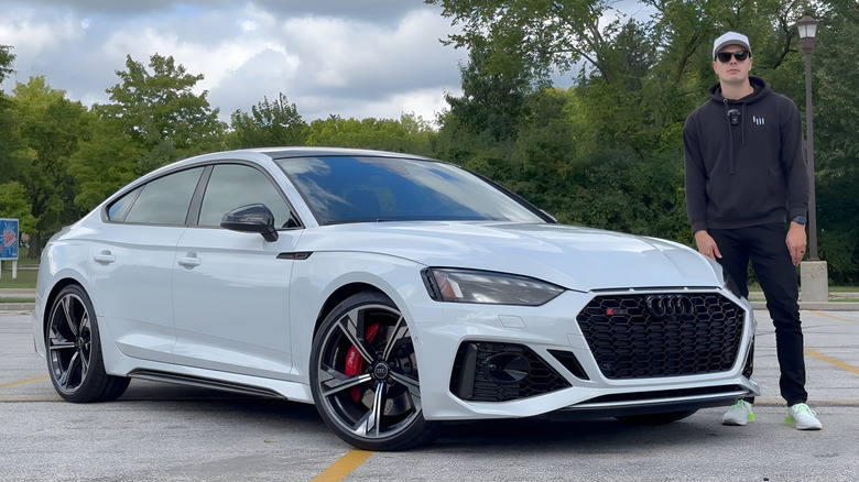 A man standing in front of a 2023 Audi RS5