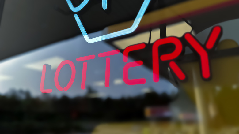 a neon lottery sign in store window