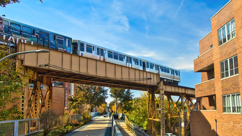 A commuter train passes over Chicago city street