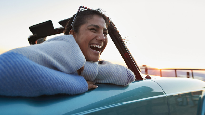Happy woman in convertible car