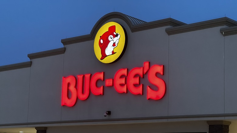 Buc-ee's logo illuminated on a storefront at night