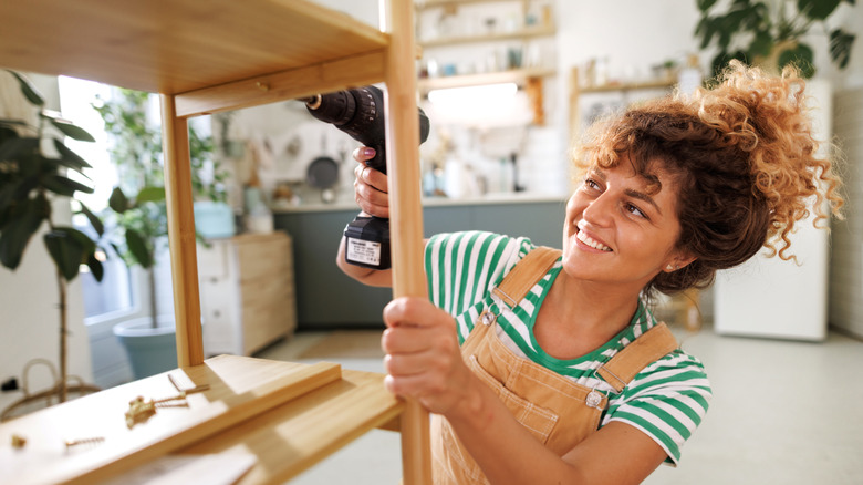 A woman drilling a table