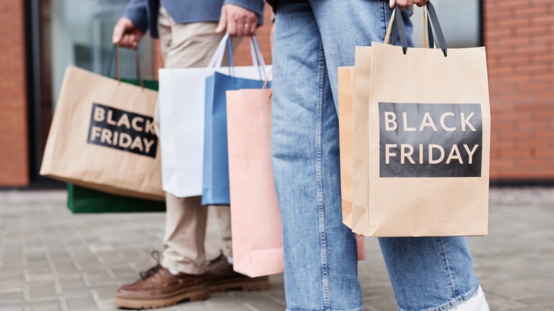 A couple holding shopping bags