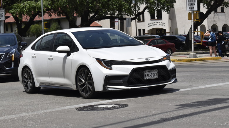 A Toyota Corolla sedan, cruising near Hermann Park in the downtown financial district of Houston.