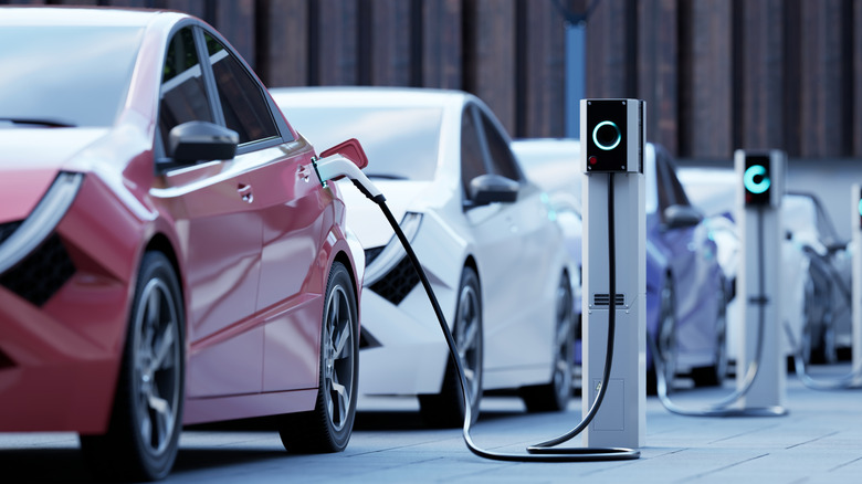 Generic electric cars recharging on a street