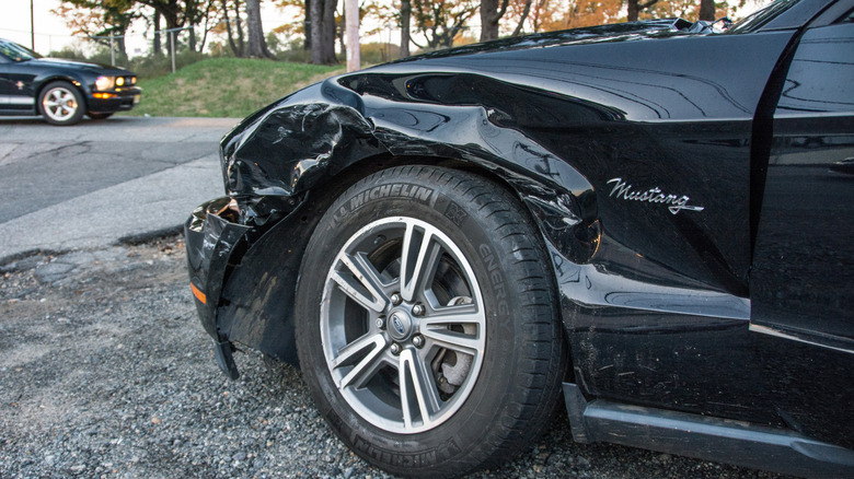 Black car with accident damage