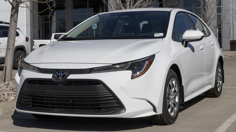 A Toyota Corolla LE compact sedan display at a dealership.