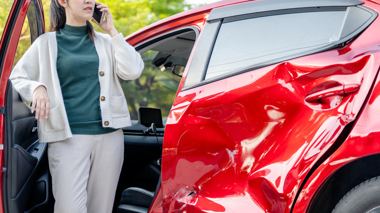 Woman on the phone after a car accident