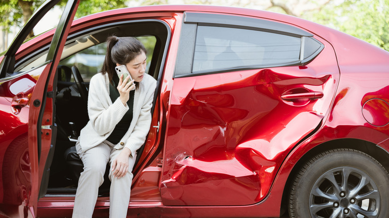 Woman talking on the phone after a car accident