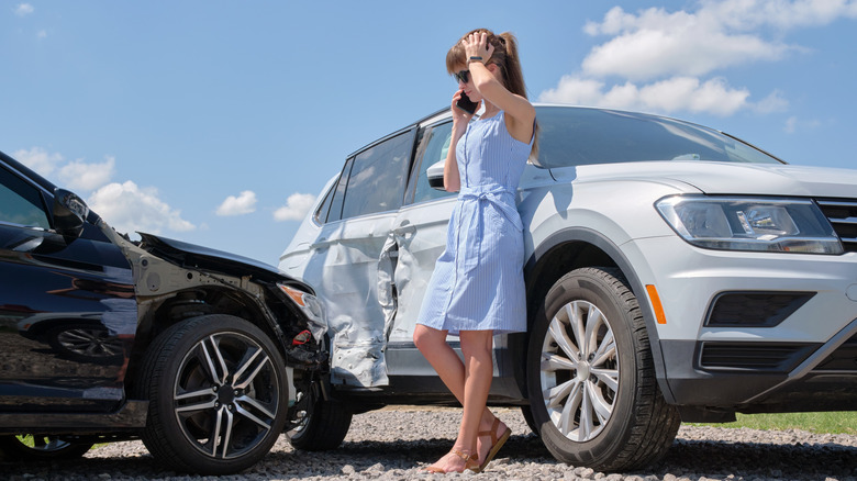 Woman talking on the phone after car accident