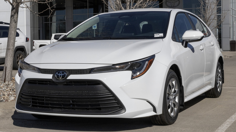 A white Toyota Corolla in a parking lot.