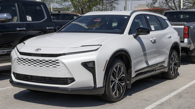 A white Toyota Crown Signia in a parking lot.