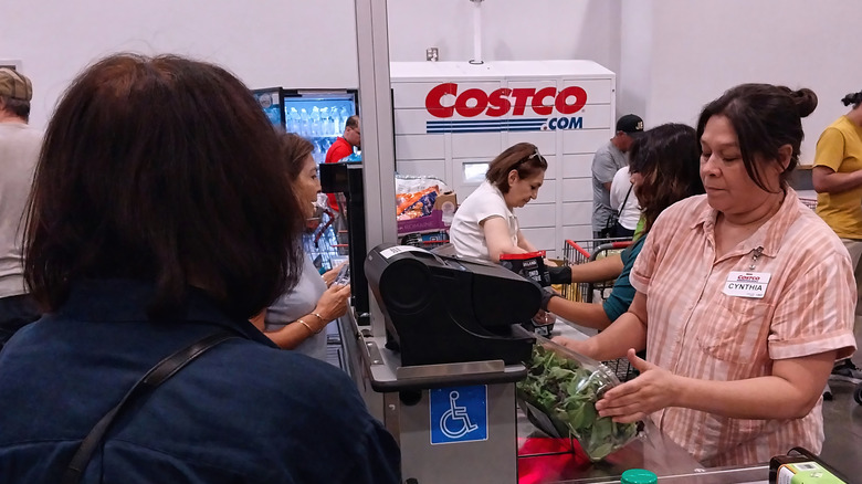 Costco cashier surrounded by shoppers