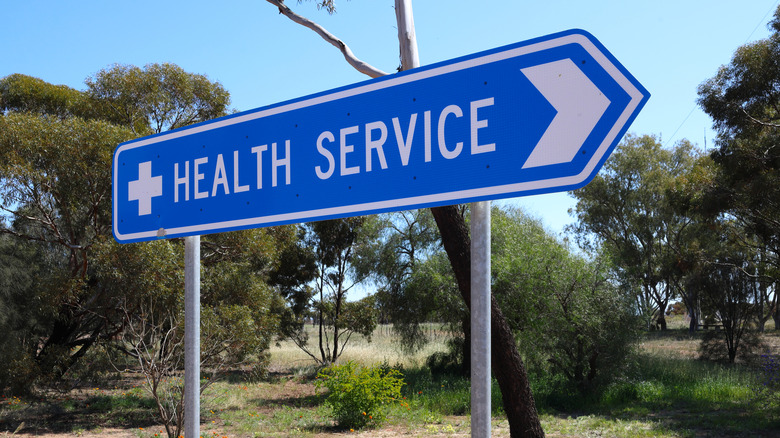 Directional road sign to health services in a rural area