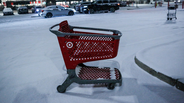 An empty Target shopping cart loose in the snow