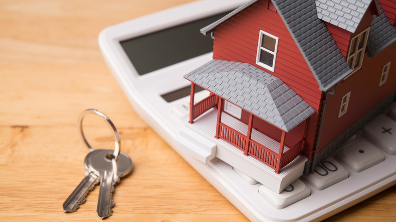 house on a calculator in front of keys