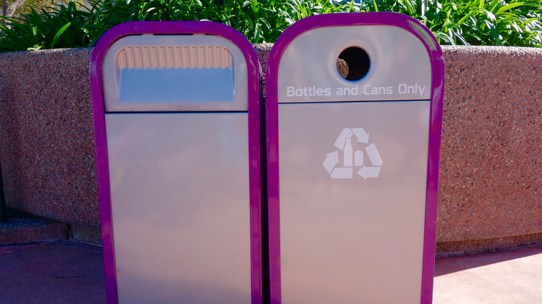 two purple and silver trash cans