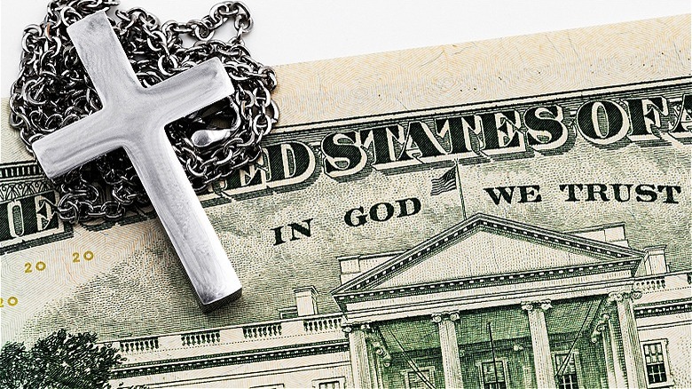 A silver cross on money