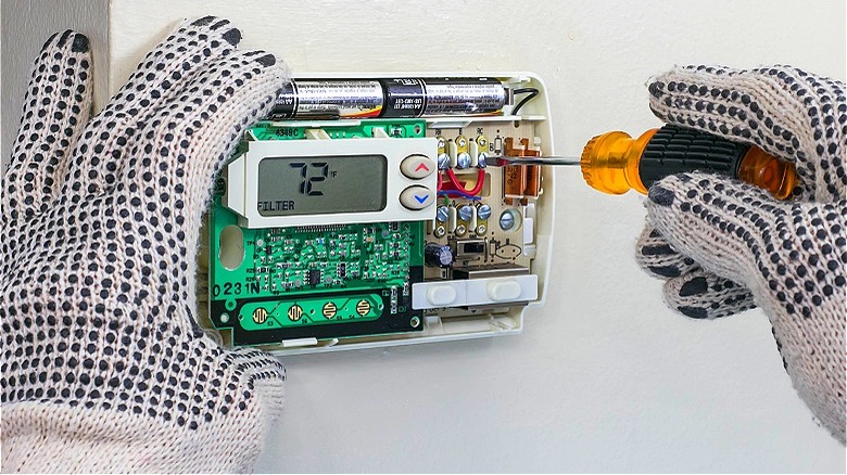 Person installing new thermostat