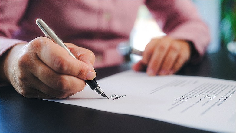 Person adding signature to document