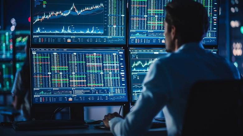 Stock trader watching multiple screens