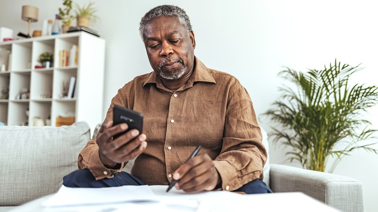 Person calculating in living room