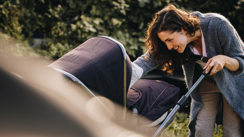 Woman pushes pram